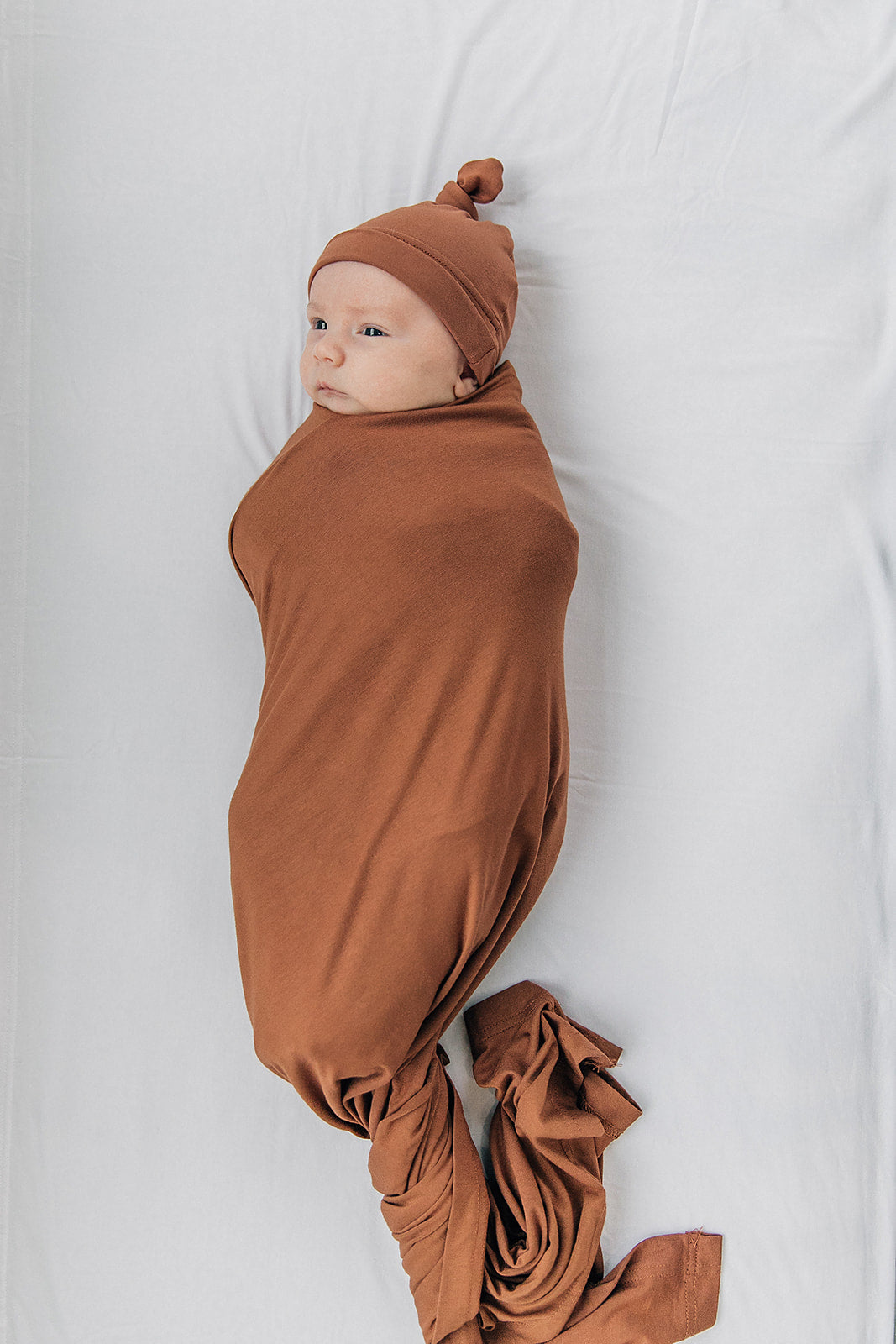 Mebie Baby Rust Stretch Swaddle. Mebie Baby Bamboo Stretch Swaddle. Gender Neutral for take home outfits and swaddling newborns. 